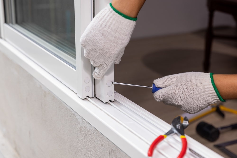 Construction,worker,repairing,the,sliding,window.,open,cap,of,adjust